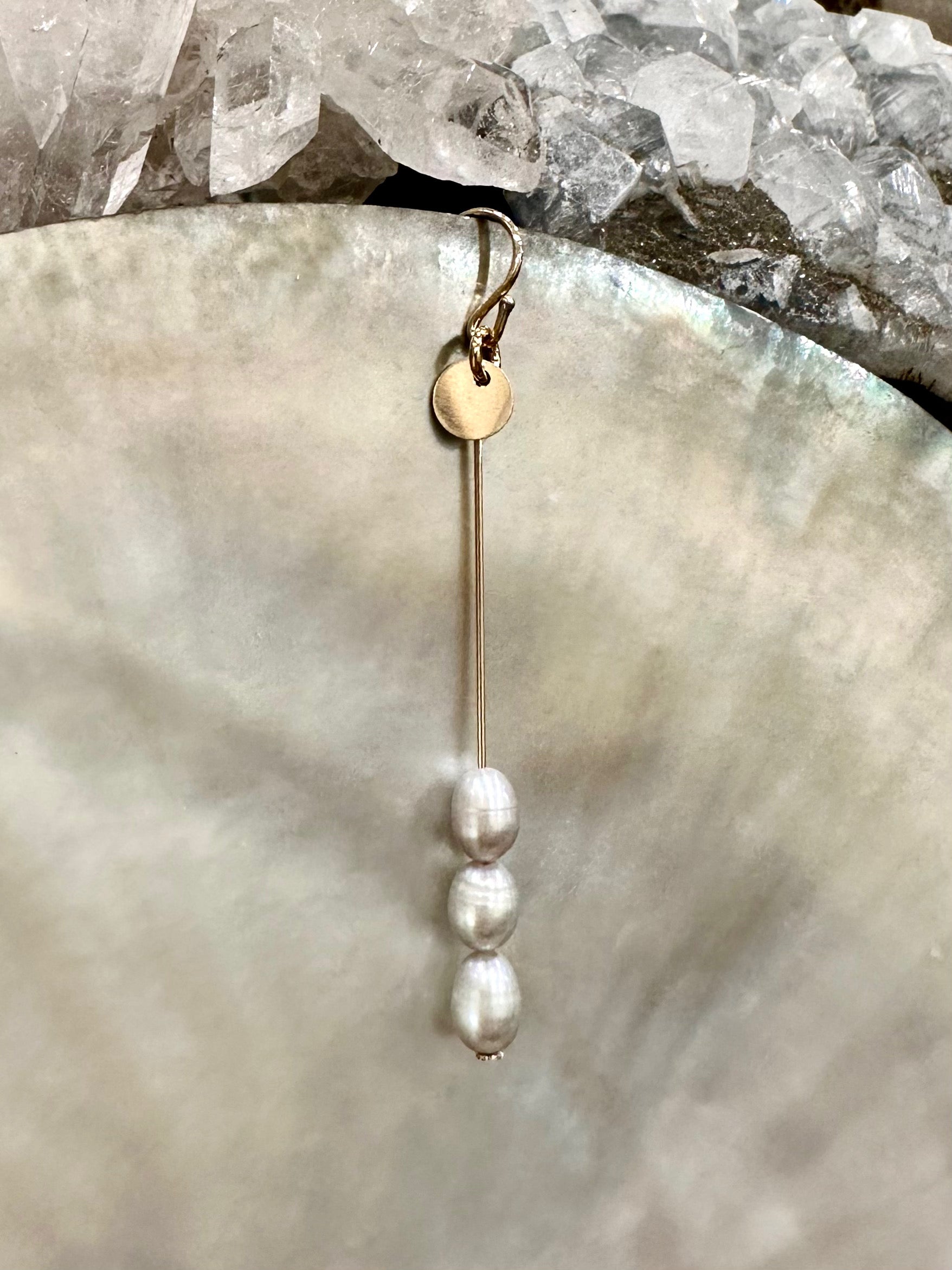 Trinity drop earrings, pearl drop earrings, gold pearl drop earrings on shell