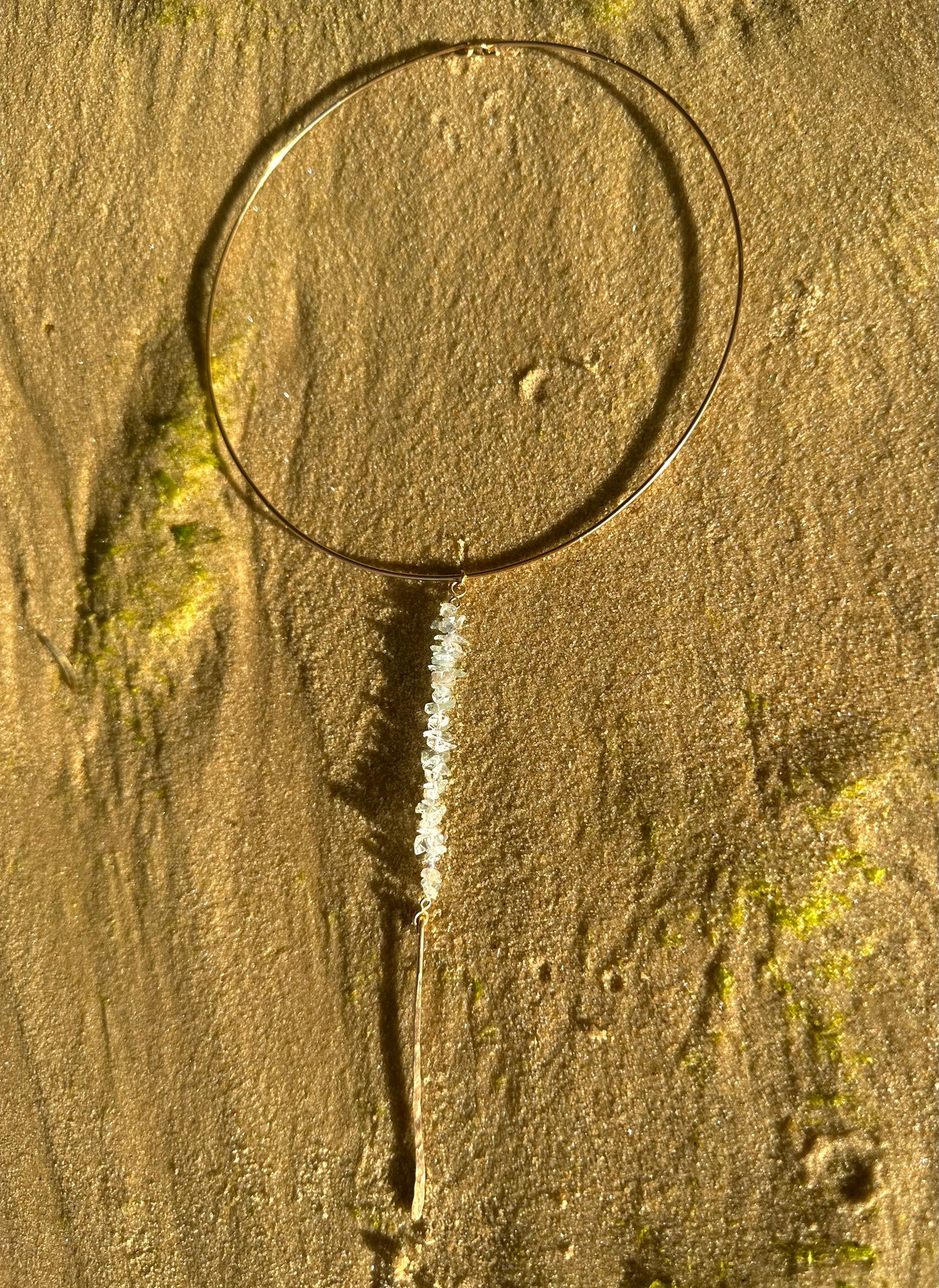 Kailani choker necklace, aquamarine choker drop necklace, gold aquamarine necklace full view on sand