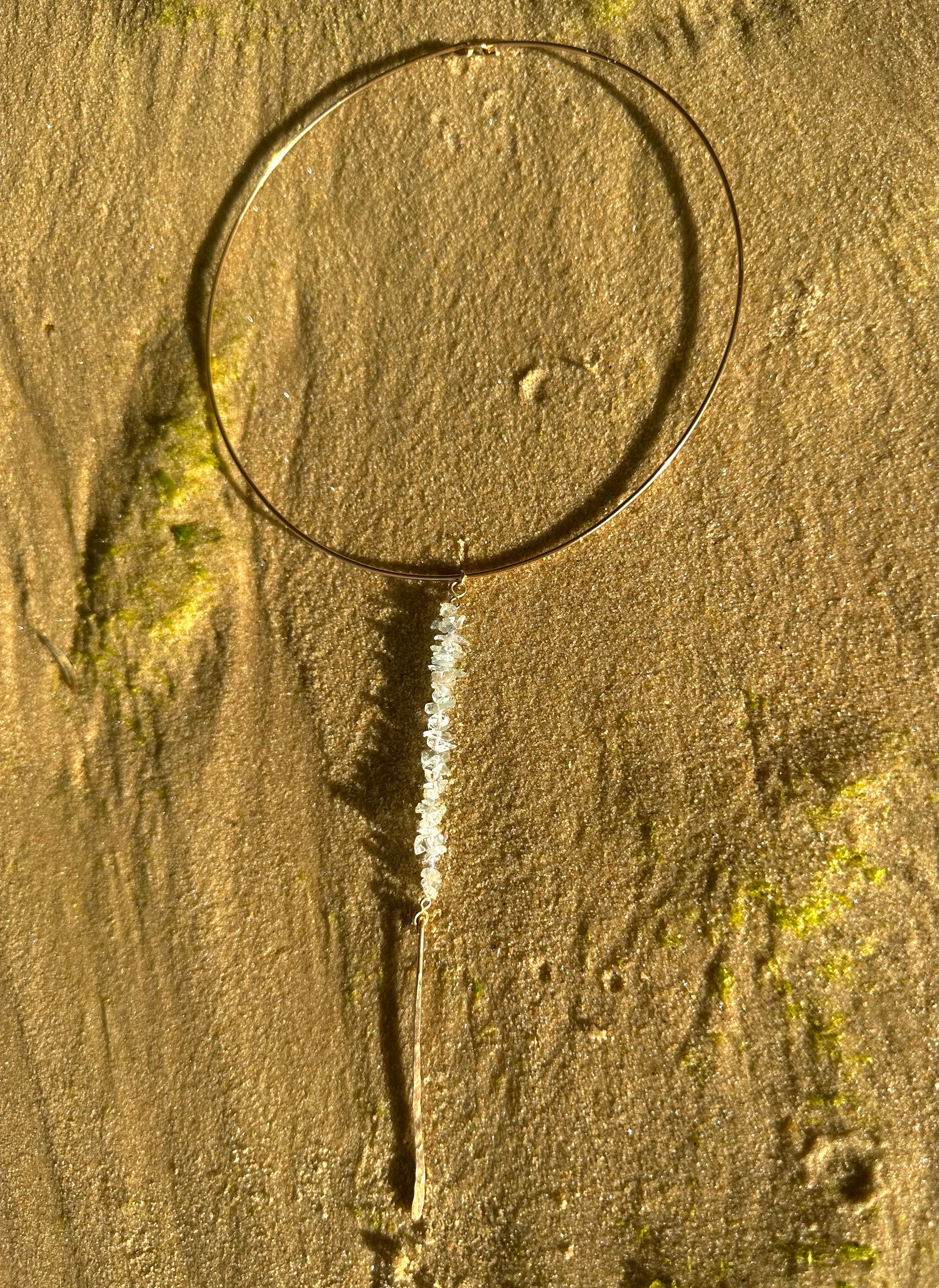 Kailani choker necklace, aquamarine choker drop necklace, gold aquamarine necklace full view on sand