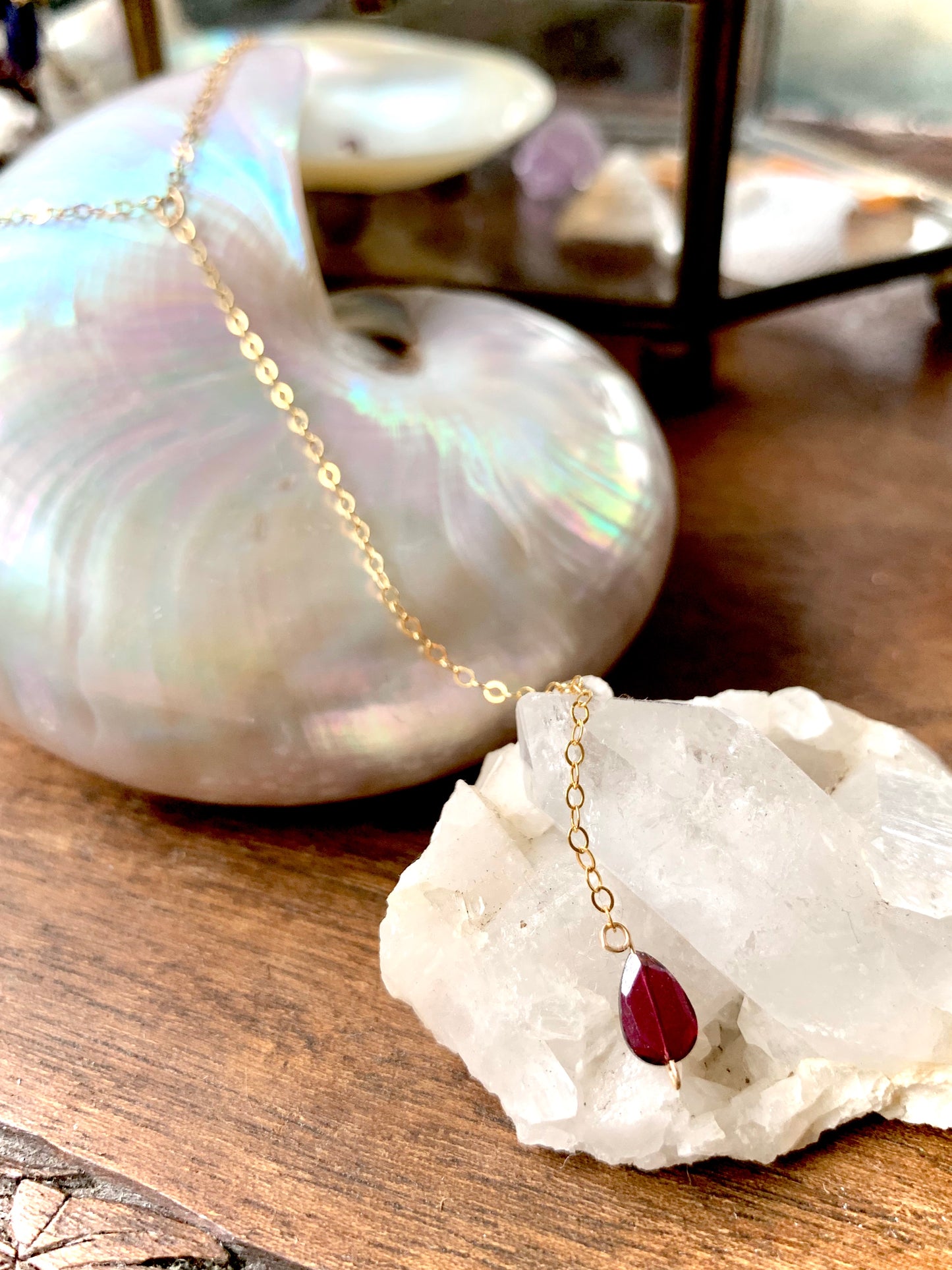 Bella drop necklace, garnet necklace, garnet on necklace close-up on crystal and shell