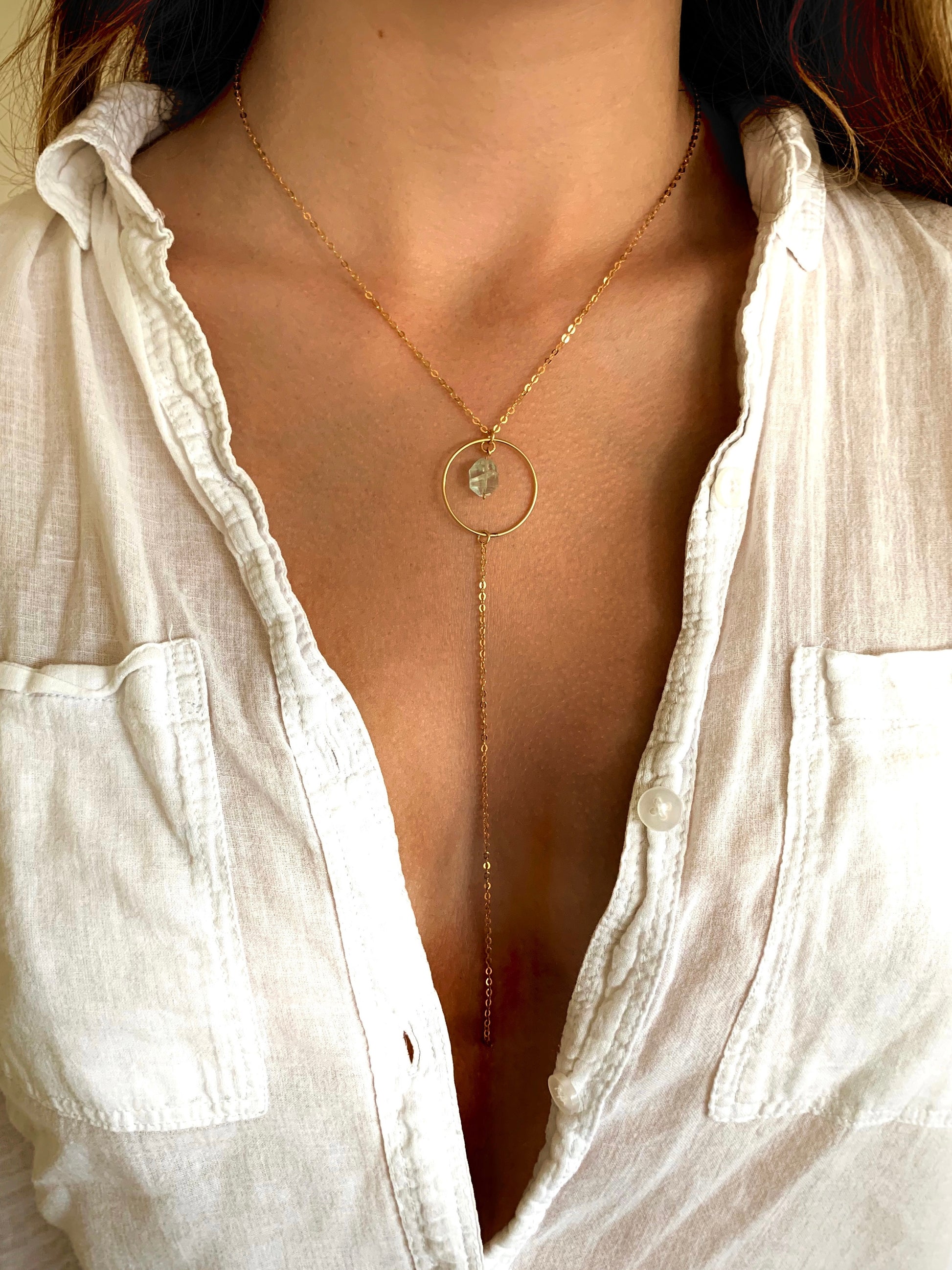 Eden necklace, aquamarine and gold necklace, blue aquamarine necklace in gold on model wearing white button up