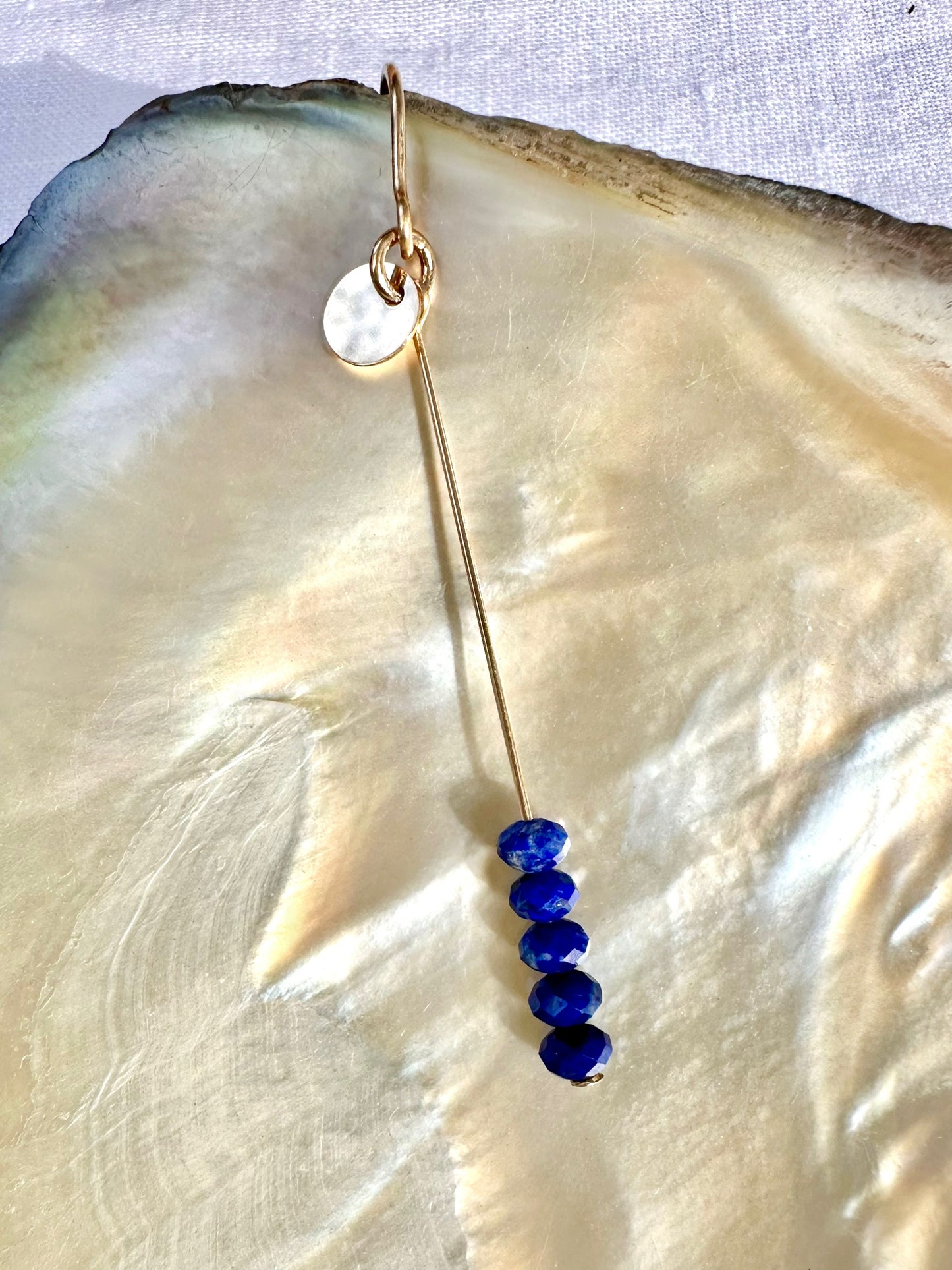 Diana drop earrings, dark blue stone earrings, gold lapis lazuli earrings on shell in sun