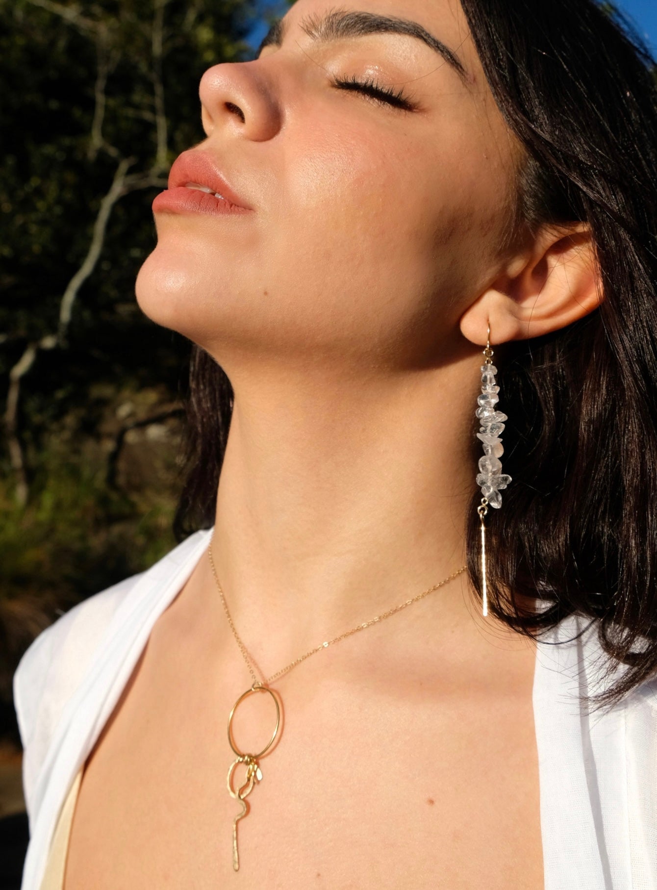 Akari drop earrings, quartz earrings, earrings in gold on model looking up paired with kirana necklace