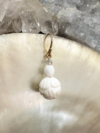Ula drop earrings, lotus earrings, earrings in gold on shell close-up