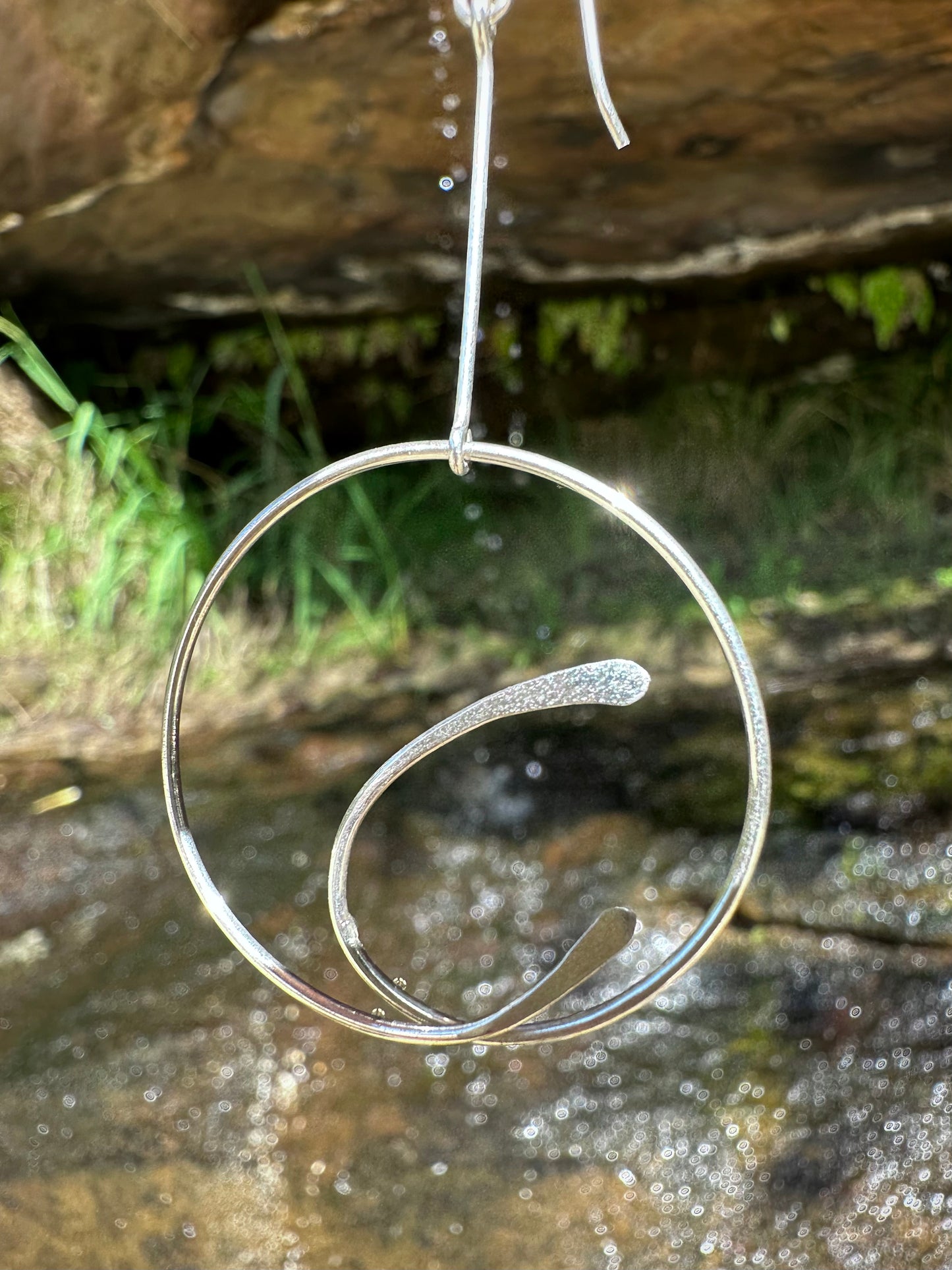 Tulin drop earrings, hammered silver earrings, close-up silver earrings waterfall