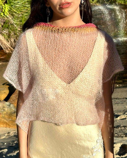 Everly knitted wool vest, oversized pink sweater vest, cropped knitted vest in sunset pink on model wearing evelyn silk dress standing close-up