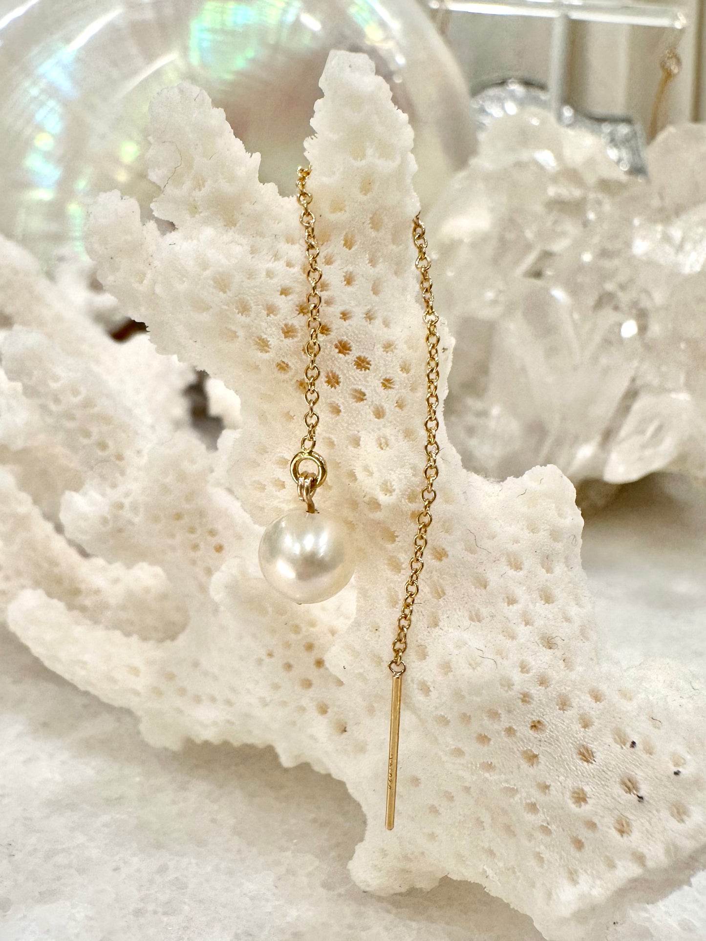 Gwendolyn pearl thread earrings, pearl drop earrings, white pearl earrings in 14k gold fill on coral close-up