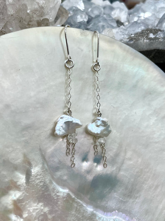 Lluvia drop earrings, cloud earrings, close-up on shell
