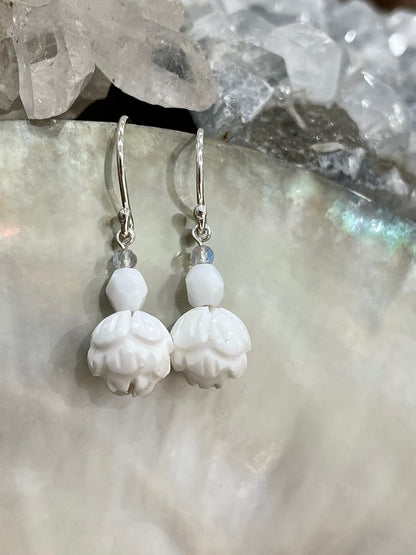 Ula drop earrings, lotus earrings, earrings in silver on shell close-up