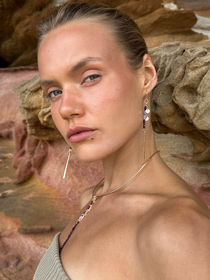Aphrodite drop earrings, garnet earrings, earrings in gold on model